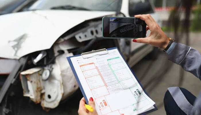 Document the accident scene - tycoonstory | tycoonstory media Documenting a truck accident in santa fe with a clipboard and smartphone, capturing vehicle damage for evidence