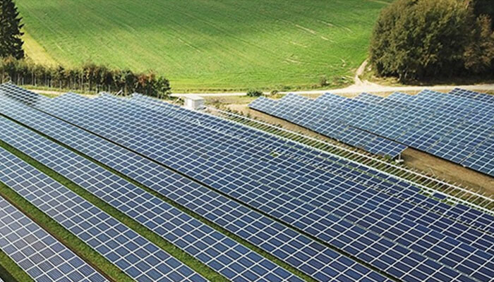 Installation complexity - tycoonstory | tycoonstory media A large solar farm with rows of solar panels, representing efficiency between string inverters vs. Central inverters.