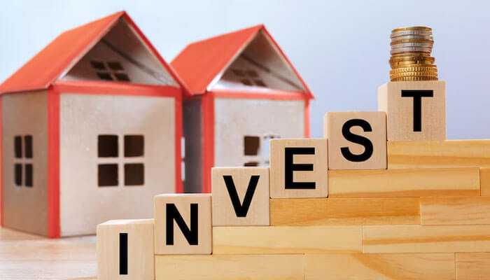 Real estate investments of jack doherty - tycoonstory | tycoonstory media Jack doherty net worth shown with invest blocks, coins, and houses symbolizing growth and investments