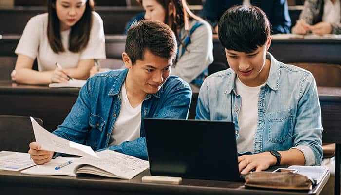 Using technology to improve cte - tycoonstory | tycoonstory media Students collaborating in a classroom, using a laptop and notes for career and technical education projects