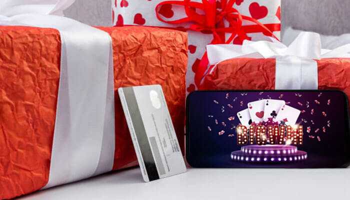 What types of game gift cards are available in the market - tycoonstory | tycoonstory media Gift boxes with a credit card and a smartphone showing an interface of a casino game, depicting online gaming gift cards.