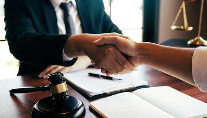 When a civil appeal is possible - tycoonstory | tycoonstory media A handshake in a legal setting with a gavel, documents, and scales, symbolizing agreement or collaboration in a civil case.