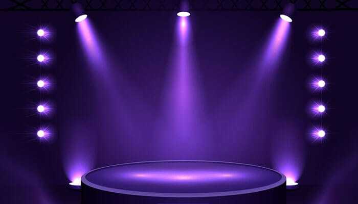 Benefits of using floodlights - tycoonstory | tycoonstory media Flood stage lights – illuminated stage with vibrant purple lighting, showcasing high-intensity floodlights for events and performances.