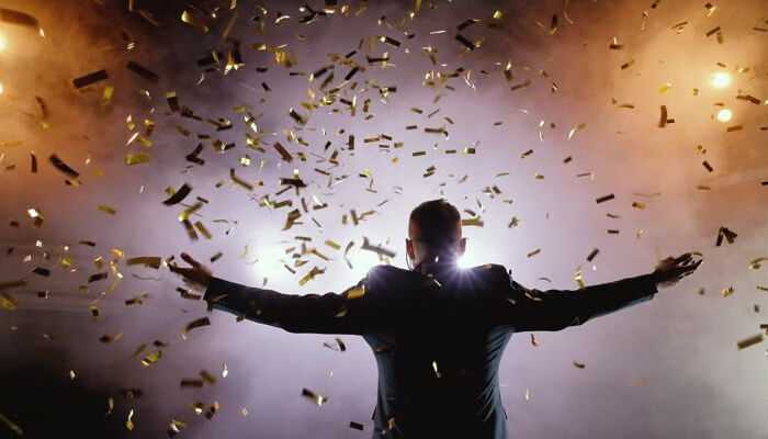 Career achievements - tycoonstory | tycoonstory media Shaquille o'Neal's Net Worth – A man celebrating success with golden confetti and dramatic lighting