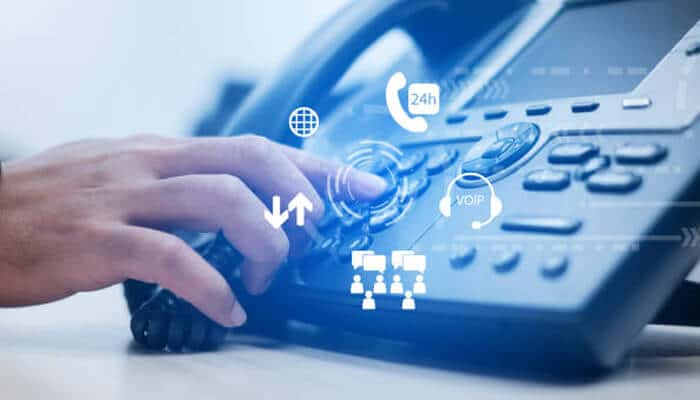 Customize your phone system - tycoonstory | tycoonstory media 812 area code – hand dialing a business phone with digital communication icons overlay, representing voip and customer support