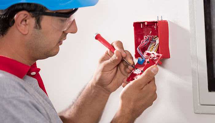 Fire alarm installation - tycoonstory | tycoonstory media Electrician inspecting and repairing wiring to ensure electrical services for home safety and prevent hazards.