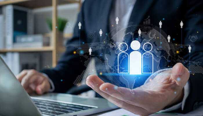 Global hiring strategy - tycoonstory | tycoonstory media Businessperson using digital technology to represent a global talent pool, highlighting how sourcing international talent is crucial for expanding and growing businesses.