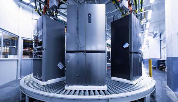 Increased energy bills and inefficient cooling - tycoonstory | tycoonstory media Modern stainless steel refrigerators on a factory production line, highlighting key refrigerator repair signs.