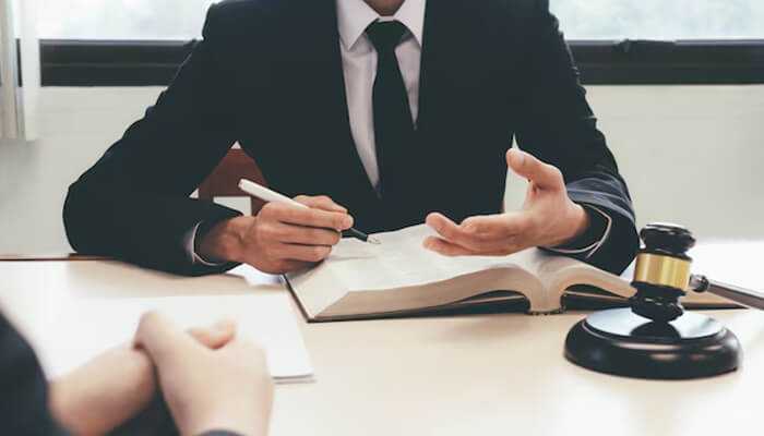 A lawyer consults a client with a gavel, symbolizing justice in wrongful death cases and business liability protection. A lawyer consults a client with a gavel, symbolizing justice in wrongful death cases and business liability protection.