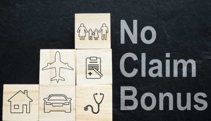 No-claim bonus - tycoonstory | tycoonstory media Wooden blocks with insurance-related icons next to the text'No Claim Bonus,' representing the benefits of NCB in insurance policies.