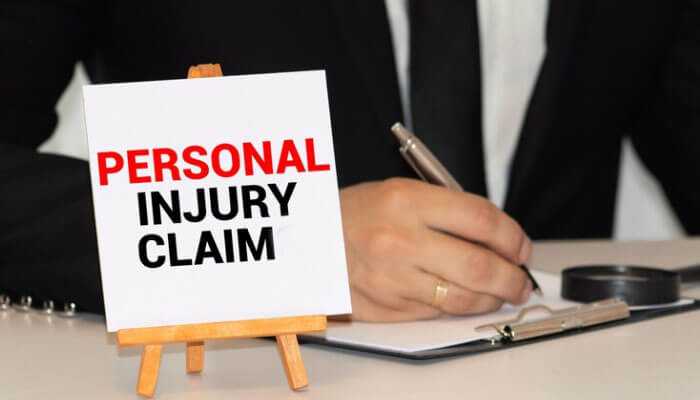 Prove liability - tycoonstory | tycoonstory media Personal injury claim sign with a lawyer writing, emphasizing the need to contact a personal injury lawyer.