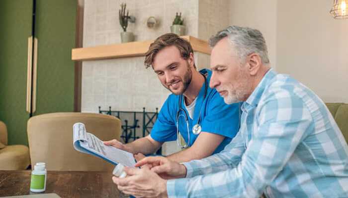 Safety and peace of mind - tycoonstory | tycoonstory media Personalized senior care solutions - a healthcare professional assisting an elderly patient with their care plan