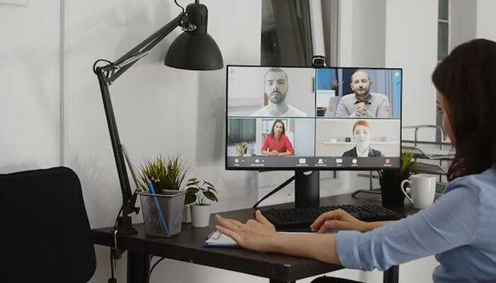 Screen recordings make cost-effective reference material - tycoonstory | tycoonstory media Remote workforce setup, where a woman joins a virtual meeting from her home office. It highlights remote collaboration using digital communication tools.