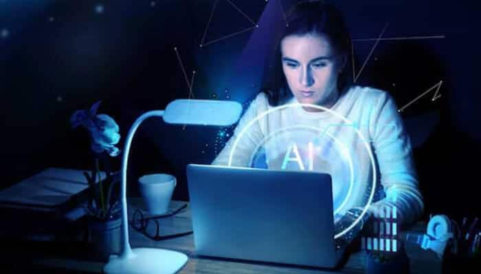 Ai video generators are transforming how we experience virtual spaces - tycoonstory | tycoonstory media Woman using a laptop with a glowing ai hologram, symbolizing ai and virtual reality integration.