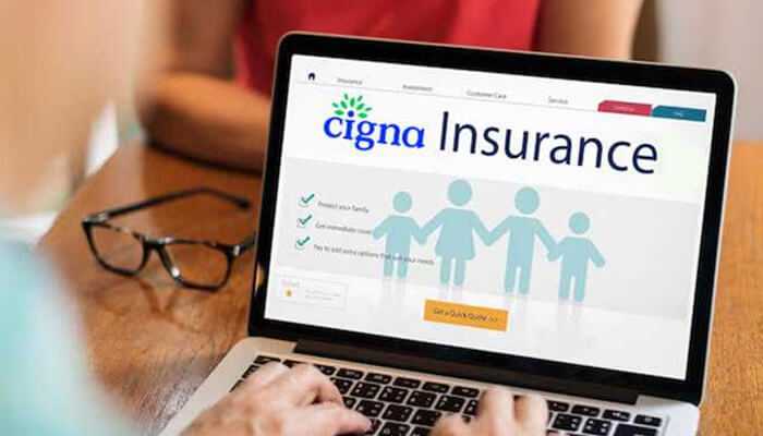 Cigna 2 | tycoonstory media Person using a laptop showing cigna health insurance family coverage details and online quote options on the screen.