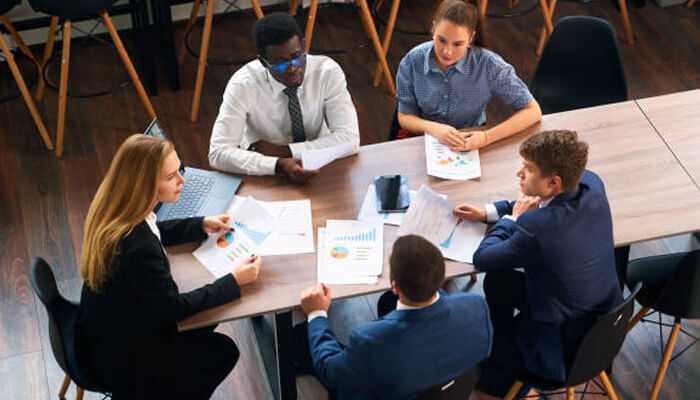 Data-driven decisions - tycoonstory | tycoonstory media Business professionals conducting a risk analysis in business, reviewing financial charts and discussing strategic decisions in a meeting.