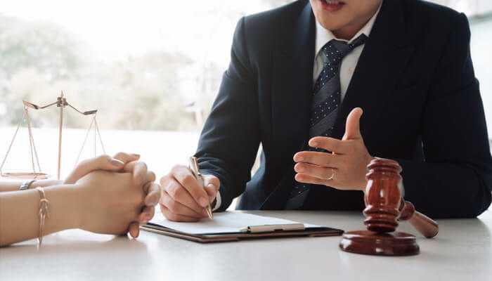 Evaluating various defences available for assault charges | tycoonstory media Legal professional advising client on assault charges in nsw, featuring gavel and scales of justice