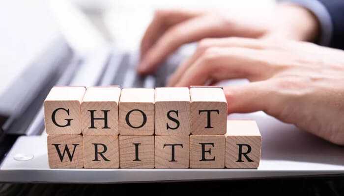 Ghost writer - tycoonstory | tycoonstory media Wooden blocks spelling ghost writer placed on a laptop keyboard, with hands typing in the background. Tycoon-worthy personal brand