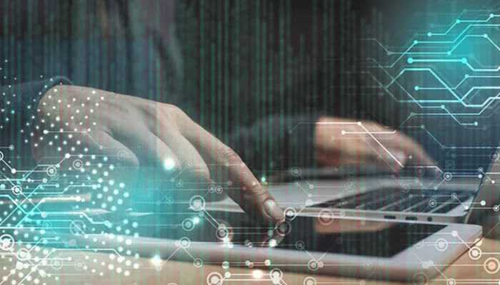 How to fix slow internet at night - tycoonstory | tycoonstory media Person typing on a laptop with digital network graphics overlay, symbolizing heavy online traffic and bandwidth congestion when internet slows down at night.