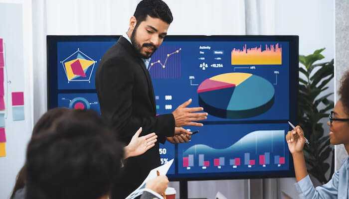Proven strategies to maximize ad spend in 2025 - tycoonstory | tycoonstory media Marketing team analyzing data charts and graphs on a screen during a strategy meeting, showcasing trends and metrics related to performance marketing in 2025.
