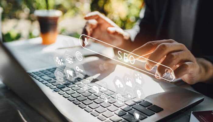 Types of seo - tycoonstory | tycoonstory media Digital marketing expert working on a laptop with seo analytics icons overlayed, representing the services of the best seo company in australia