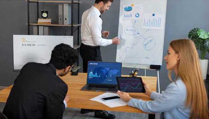 Utilizing data quality indicators for strategic insights - tycoonstory | tycoonstory media Professionals analyzing data quality indicators in a meeting with charts and digital visuals.