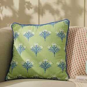 World of covers - tycoonstory | tycoonstory media Elegant green cushion cover with blue floral prints, adding a stylish and cozy touch to your home decor.