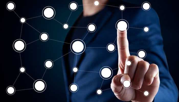 4 common multi-touch attribution models | tycoonstory media A business professional interacting with a digital network interface, representing the concept of multi-touch attribution across various customer journey touchpoints.