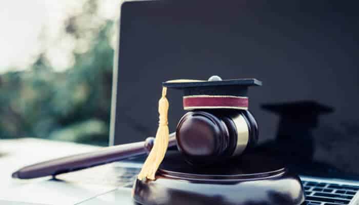 A smarter way to earn your law doctorate | tycoonstory media Gavel with graduation cap on laptop symbolizing online juris doctor of law degree programs