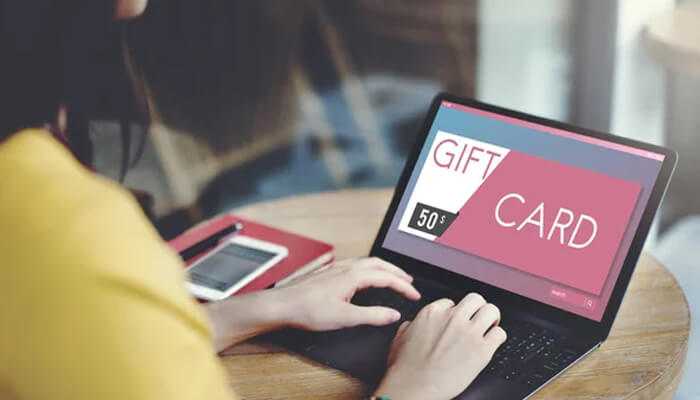 Balance before making online orders | tycoonstory media A person using a laptop to check gift card balance online, ensuring hassle-free transactions while shopping.