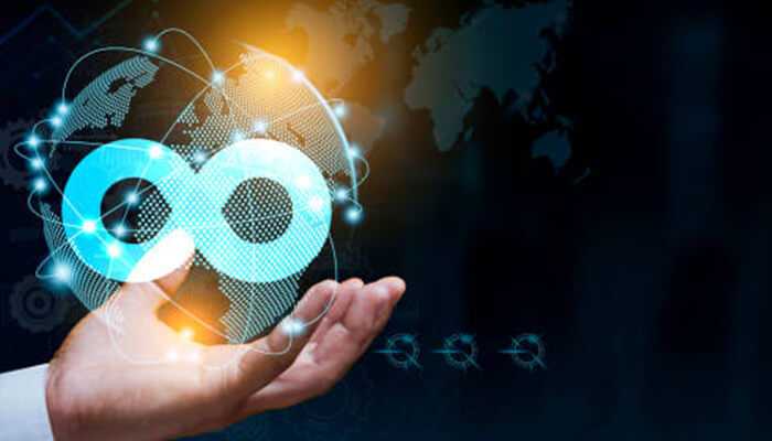 Building 1 | tycoonstory media Hand presenting a digital devops architecture symbol with a connected global network in the background.