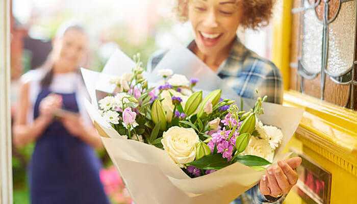 Flower bouqet | tycoonstory media Woman with flower bouquet reflecting floristry and personality types.