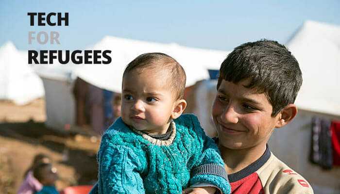 From emergency response to long-term development | tycoonstory media A young refugee boy holding a baby smiles in a displacement camp, representing the impact of unicef education and tech for refugees in providing hope through technology.