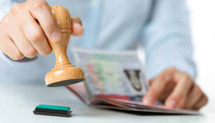 Immigration hold-tycoonstory 1 | tycoonstory media Official immigration document being stamped — green card lawyer support for visa and green card processing