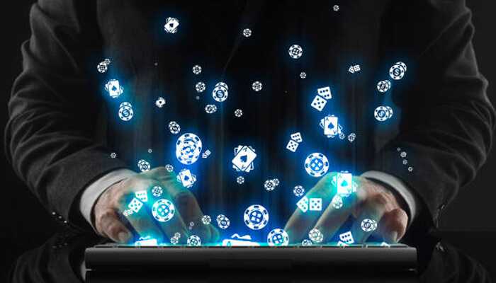 Online gambling | tycoonstory media Hands typing on a laptop with casino icons floating above, representing the evolution of legal online gambling and digital gaming technology.