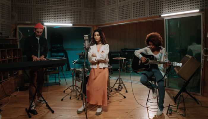 Rehearsal spaces | tycoonstory media A team of musicians and producers in a recording studio, focused on creating music in a professional rehearsal spaces.