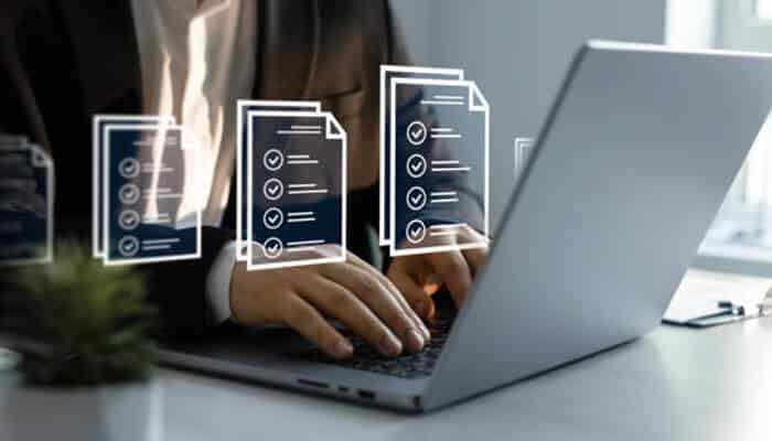 Step-by-step guide to a kubernetes upgrade_ tycoonstory 1 | tycoonstory media A professional working on a laptop with floating digital checklists, symbolizing a step-by-step guide to kubernetes upgrades for streamlined business operations.