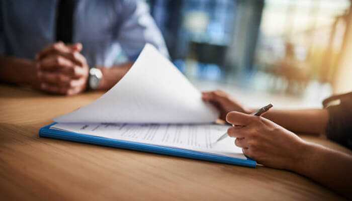 Why proper documentation matters | tycoonstory media A business owner reviewing insurance documentation, emphasizing the importance of having proper records for tornado damage insurance claims