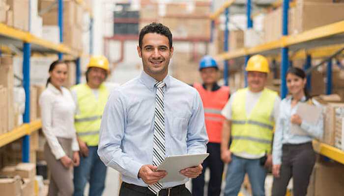 Benefits of using tpr | tycoonstory media Warehouse manager leading a team with digital tools, representing efficient inventory solutions through total product resource.