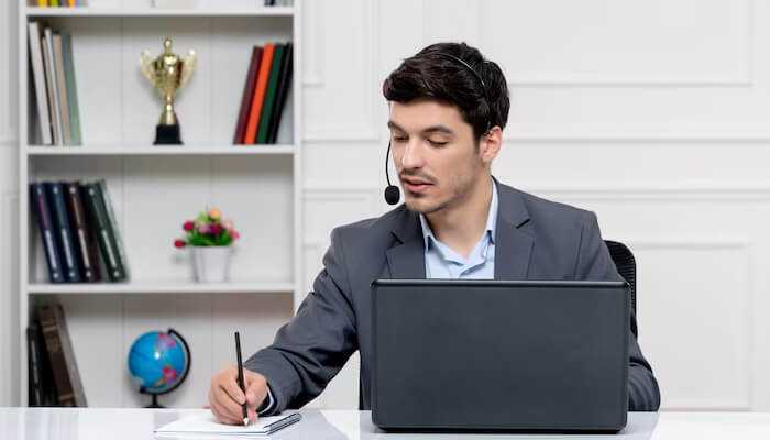 Border-less communication skills | tycoonstory media Pa as global family coordinator managing international tasks with headset and laptop in a professional office setting.