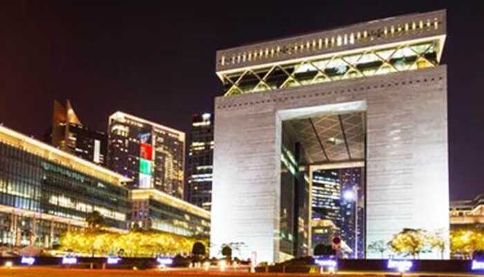 Business benefits at difc | tycoonstory media Night view of the dubai international financial centre (difc) lit up with modern office buildings in the background, showcasing dubai’s financial hub.
