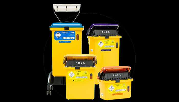 Common violations in hospital waste disposal and how to avoid them | tycoonstory media Multiple yellow hospital waste bins labeled for different types of medical waste, emphasizing proper segregation in hospital waste disposal to avoid common violations.