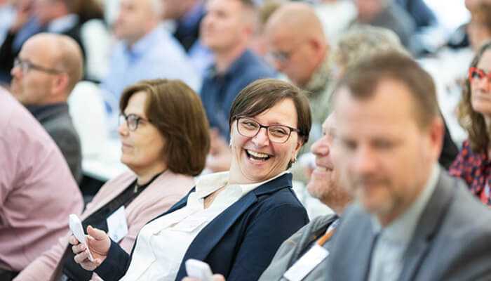 Company culture | tycoonstory media Business professionals engaged in a collaborative meeting with laptops and tablets showing data, highlighting teamwork and discussion - employment law solicitors supporting workplace compliance