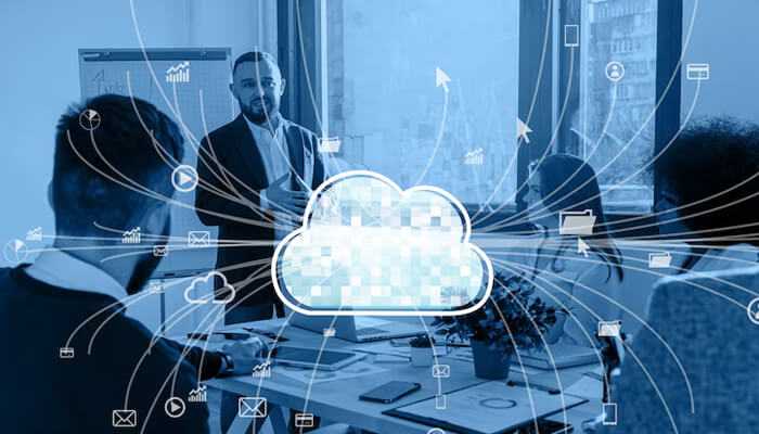 Core features of cloud development services | tycoonstory media Business meeting with team discussing cloud development services, with digital cloud network icons illustrating data connectivity and collaboration.