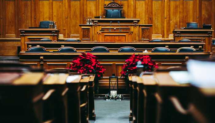 Handling settlement discussions | tycoonstory media A formal courtroom setup symbolizing the legal process and environment where defending employment tribunal claims takes place.