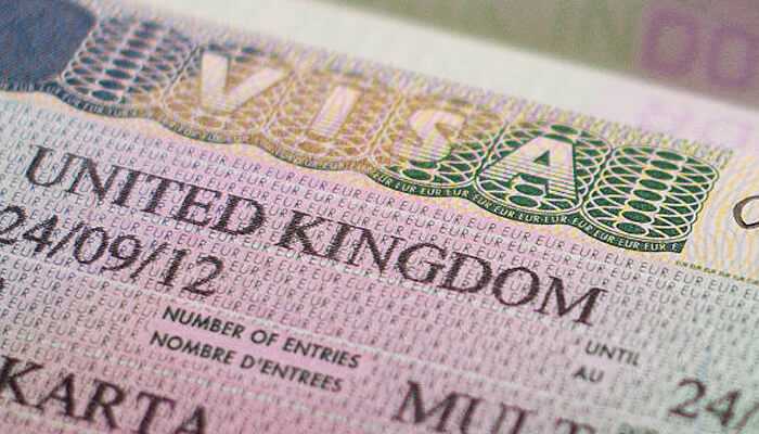 How to choose between the uk senior worker visa and specialist worker visa in 2025 | tycoonstory media Uk worker visa document showing the words'UNITED KINGDOM' and 'VISA' in a close-up shot.