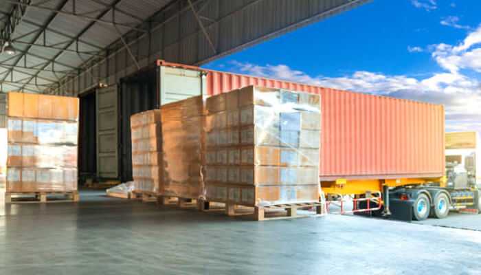 Multi-carrier management is a hassle | tycoonstory media A stack of cardboard boxes ready for delivery, highlighting solutions for the cheapest shipping in canada for e-commerce businesses.