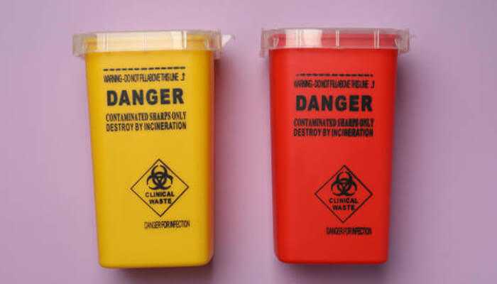 Opt for eco-friendly and cost-effective solutions | tycoonstory media Two medical sharp containers, one yellow and one red, labeled with biohazard warnings for clinical waste disposal, placed against a purple background.