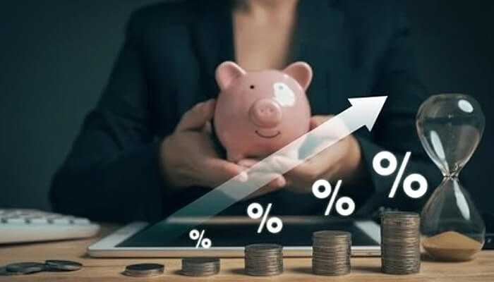 Racking up high-interest debt | tycoonstory media A person holding a piggy bank with coins and an upward trend graph, symbolizing the importance of avoiding financial mistakes and making smart investment choices for growth.
