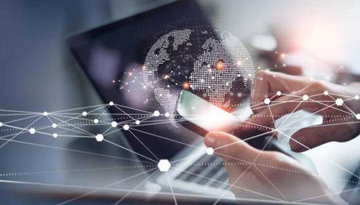 Telecom 1 | tycoonstory media Person using a smartphone with a digital globe and network overlay, representing advanced telecom expense management through global connectivity and data tracking.